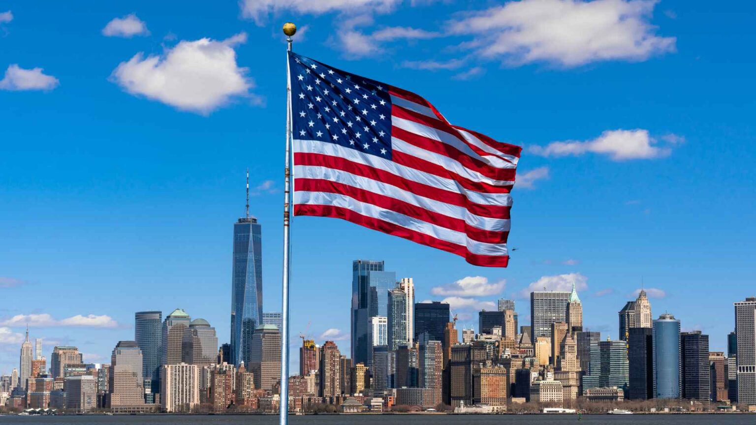 American flag next to sky scrapers