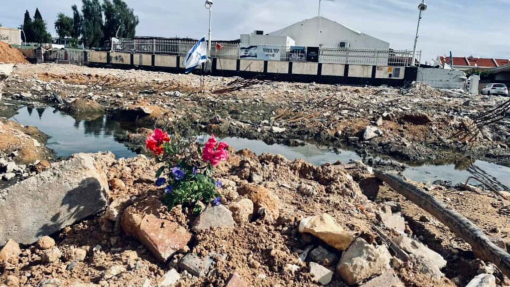 Flowers blooming out of the remains of the Sderot police station (December 2023)