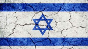 Israeli flag painted over dry and cracked earth